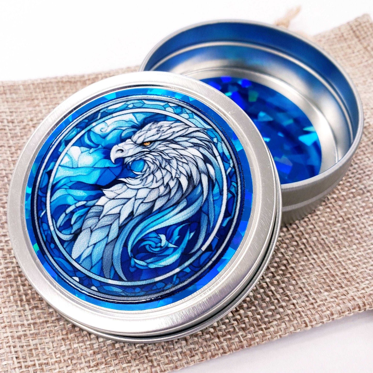Griffin Container. Small round metal tin with blue mythological griffin eagle graphics. Stocking stuffer gift.