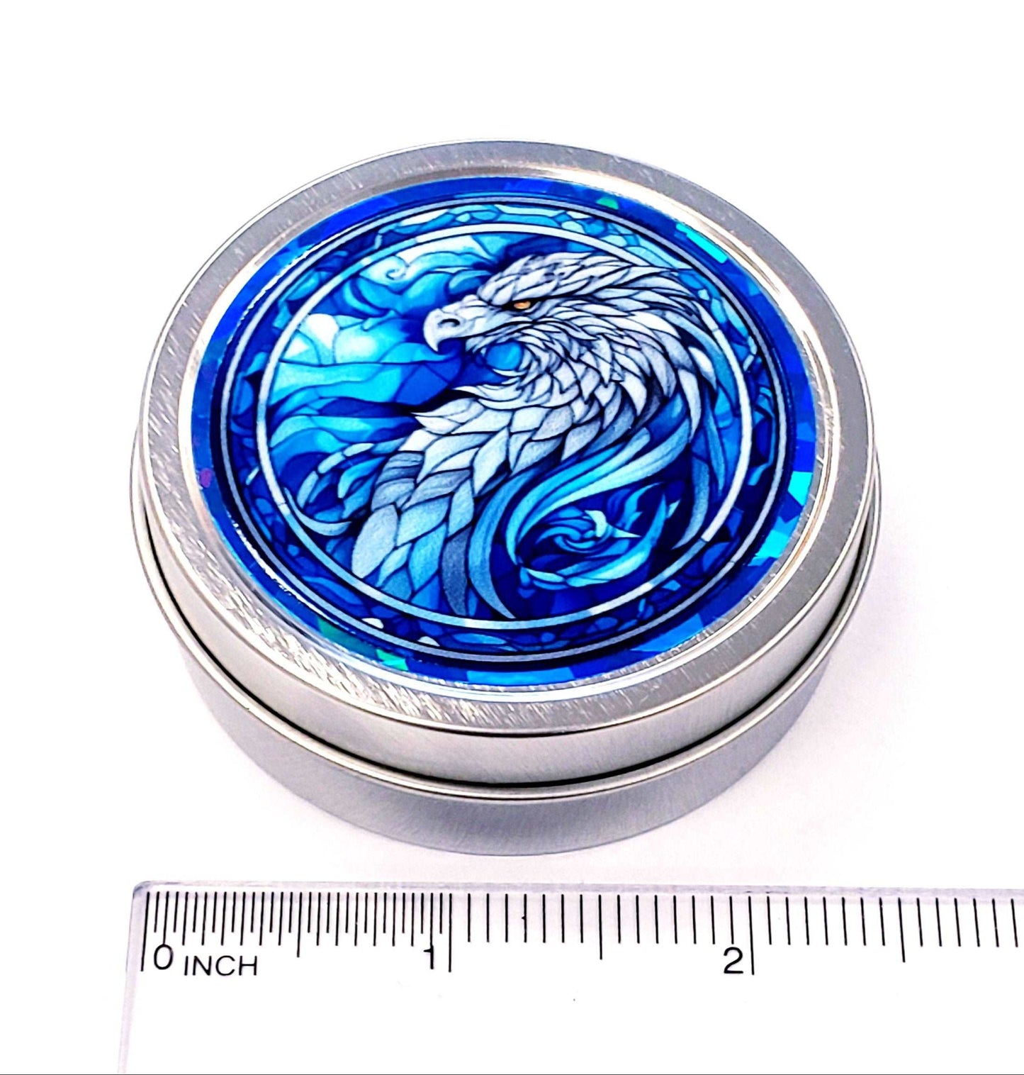 Griffin Container. Small round metal tin with blue mythological griffin eagle graphics. Stocking stuffer gift.