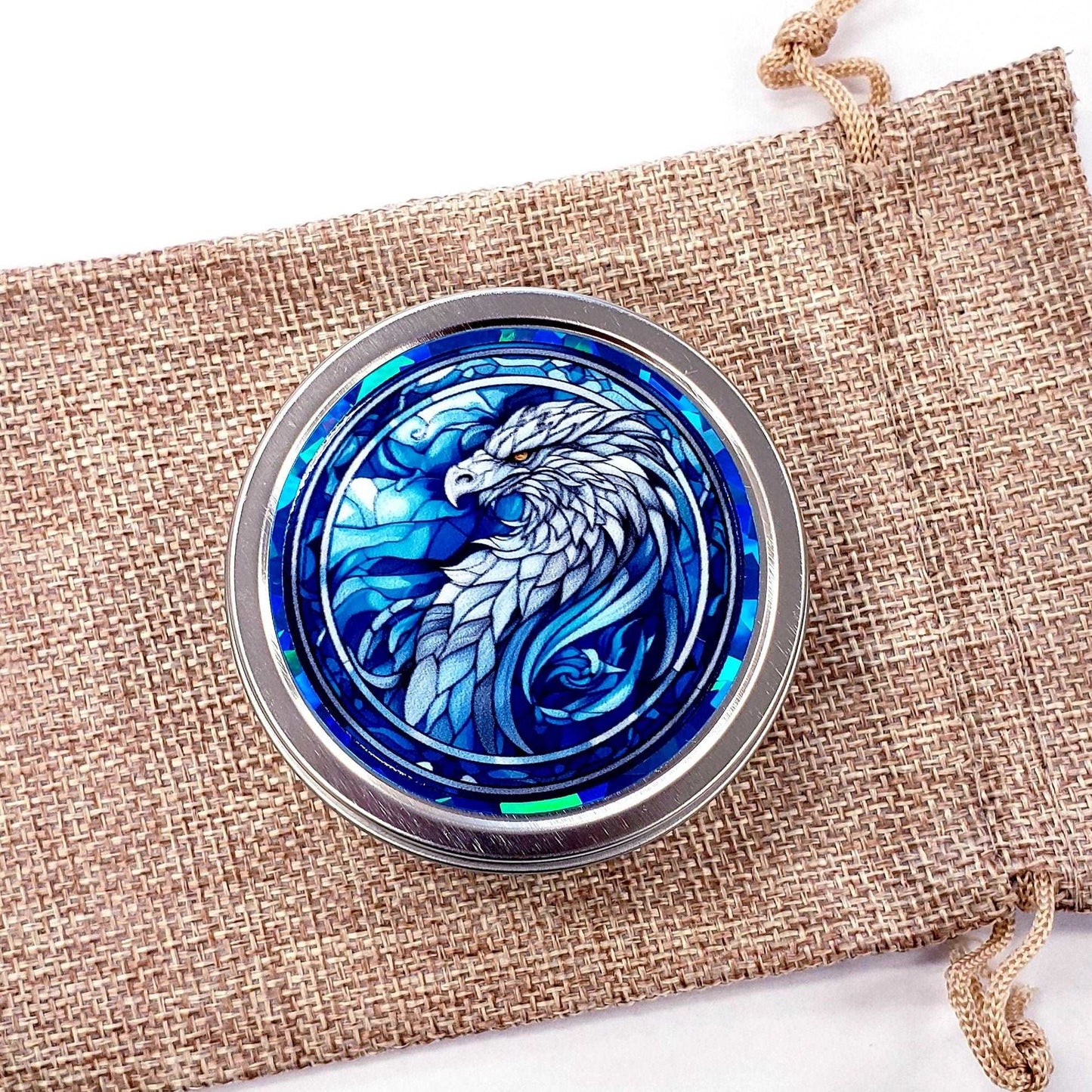 Griffin Container. Small round metal tin with blue mythological griffin eagle graphics. Stocking stuffer gift.