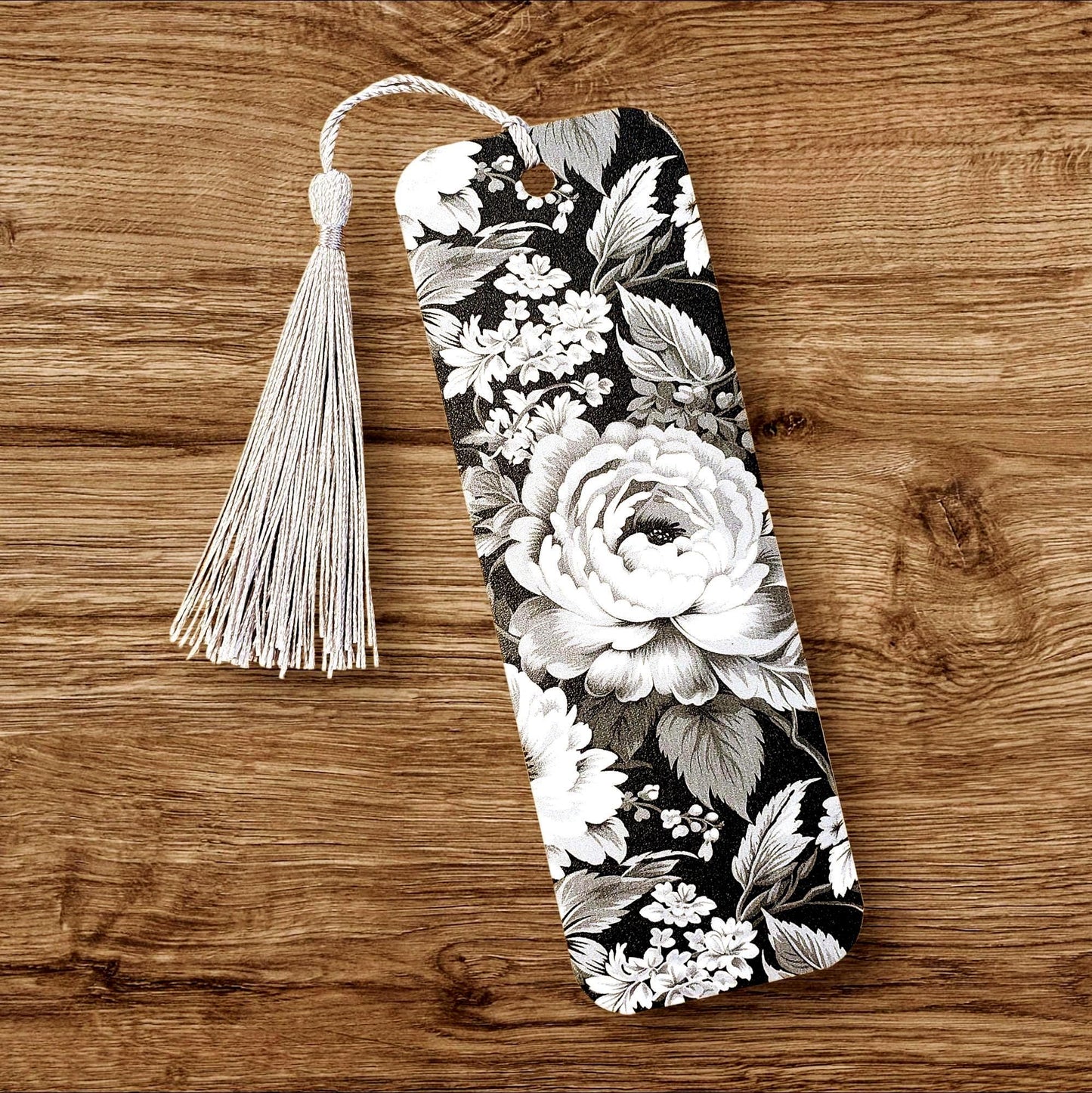 Black and white floral printed bookmark with silver tassel. Double-sided.