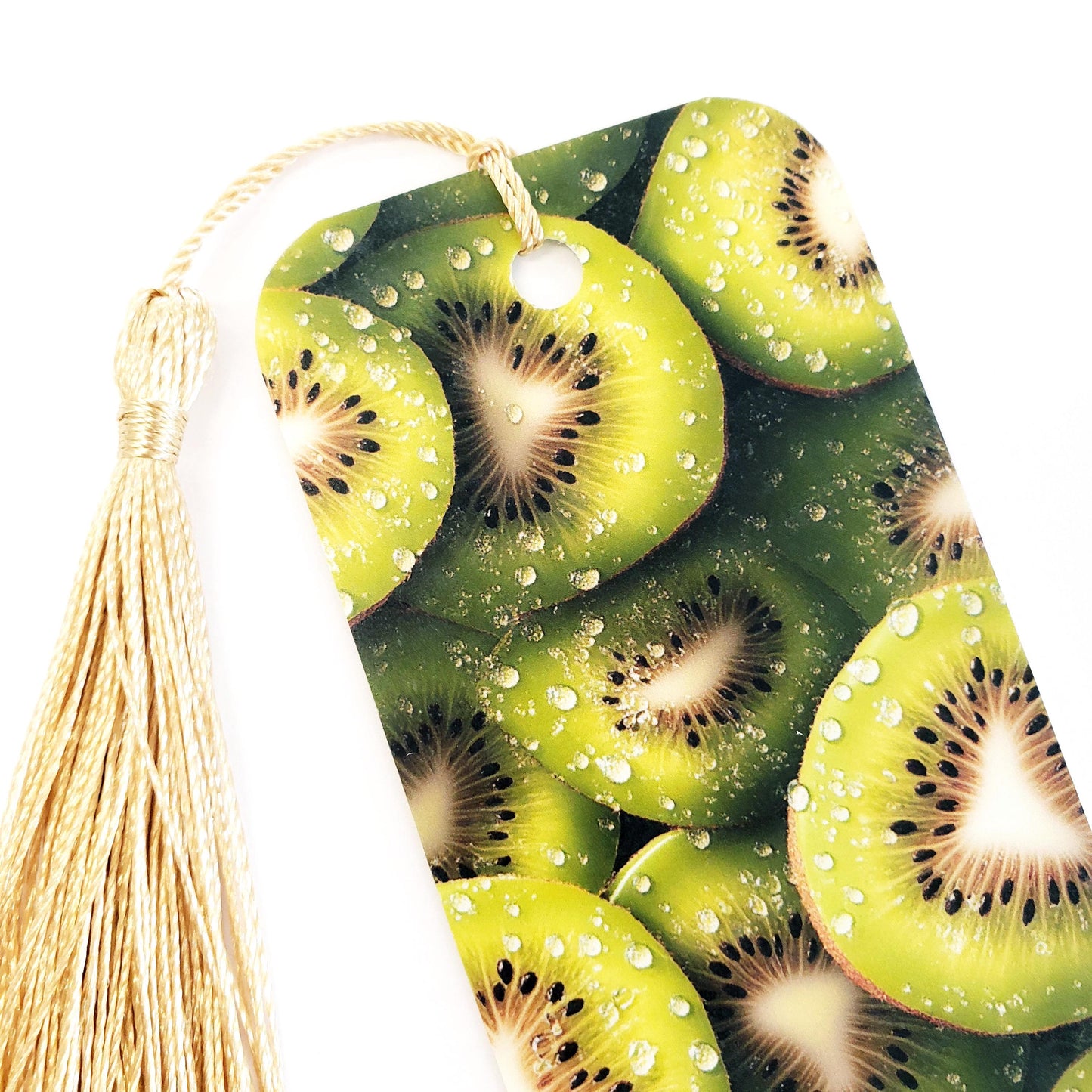 Kiwi fruit bookmark with gold tassel. double-sided bookmark with photograph of sliced kiwi fruit.