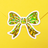 Set of 20 sparkly yellow bow stickers with a white outline.