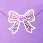 Set of 20 sparkly lilac purple bow stickers with white outline.