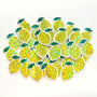 May include: A collection of yellow lemon-shaped sticker embellishments with green leaves. The lemons are sparkly with green leaf and clear borders.