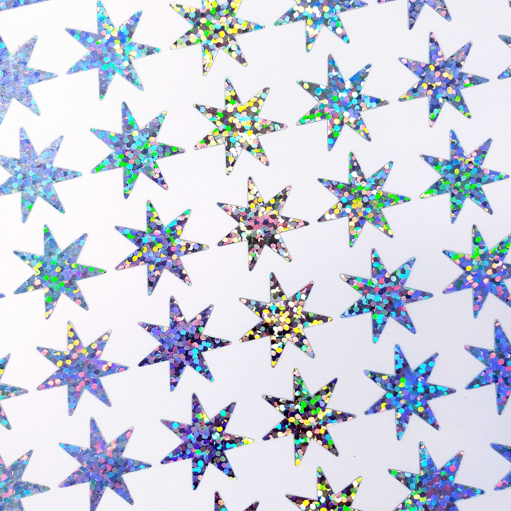 Seven Pointed Starburst Sticker Sheet, set of 48 sparkly star stickers for ornaments, journals, planners, gift tags and craft projects.