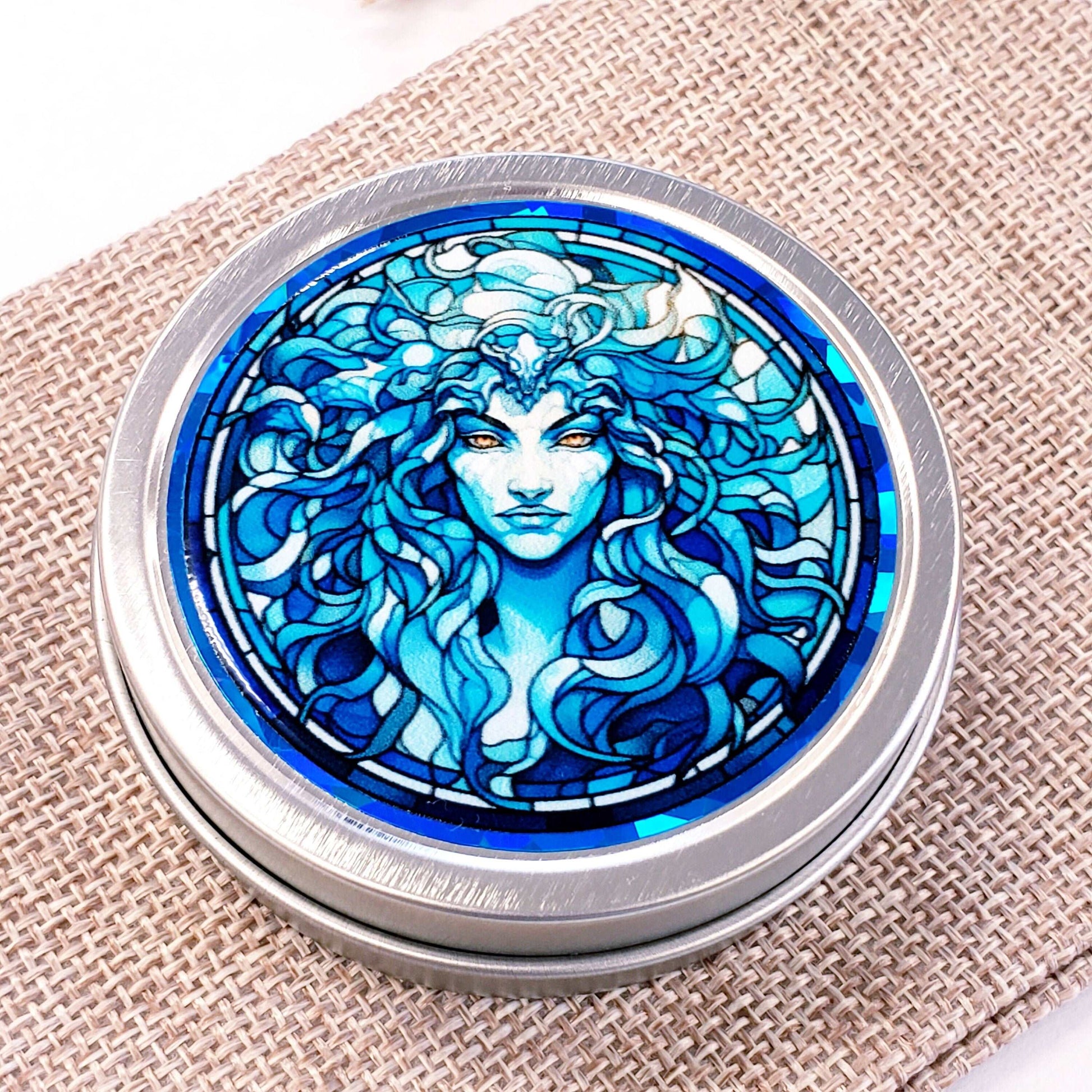 Medusa Gift Container. Small round metal tin with Medusa the mythological Greek goddess in blue graphics. Stocking Stuffer gift for her.