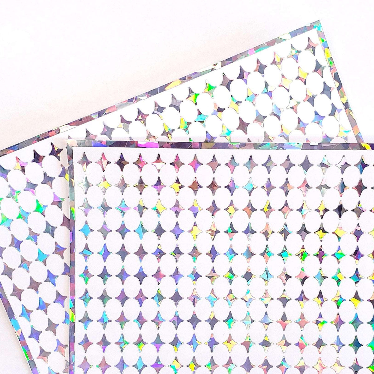 Small Silver Four-Pointed Stars Sticker Sheet. Set of 231 sparkly silver peel and stick vinyl star decals for nails, planners and ornaments.