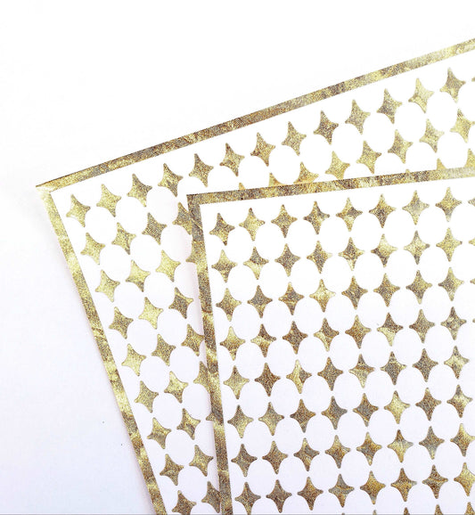 Small Gold Four-Pointed Stars Sticker Sheet. Set of 231 metallic gold peel and stick vinyl star decals for nails, planners and ornaments.