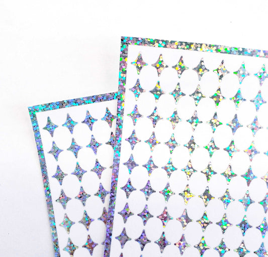 Small Silver Four-Pointed Stars Sticker Sheet. Set of 231 silver glitter peel and stick vinyl star decals for nails, planners and ornaments.