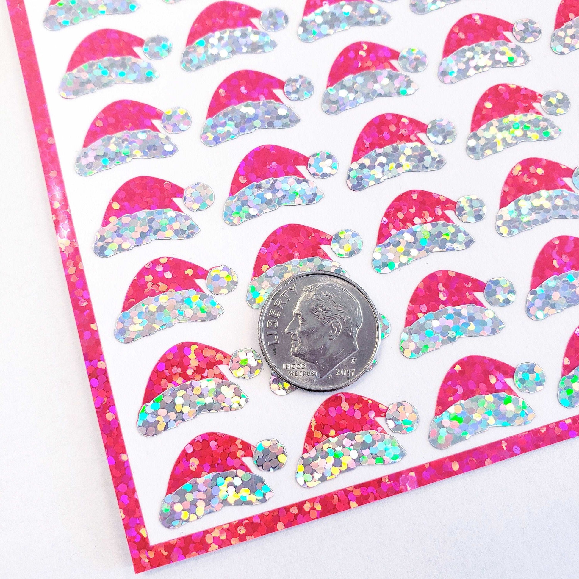 Mini Pink Santa Claus Hats Sticker Sheet. Set of 78 Santa Hat decorative glitter stickers for ornaments, crafts, envelopes and gift bags