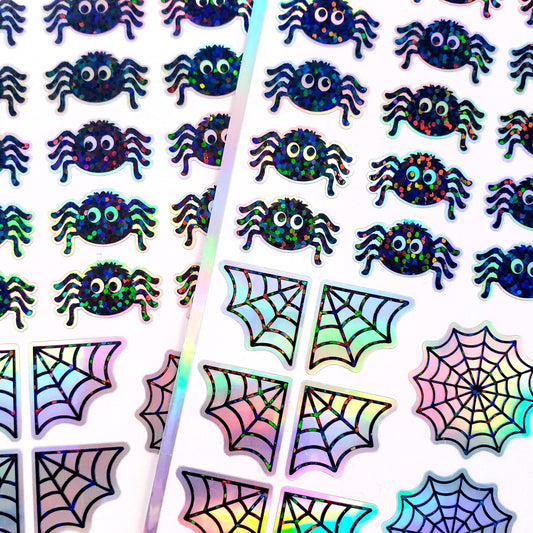 Halloween spider sticker sheet. Set of 30 peel and stick sparkly cute black spiders and spider webs.