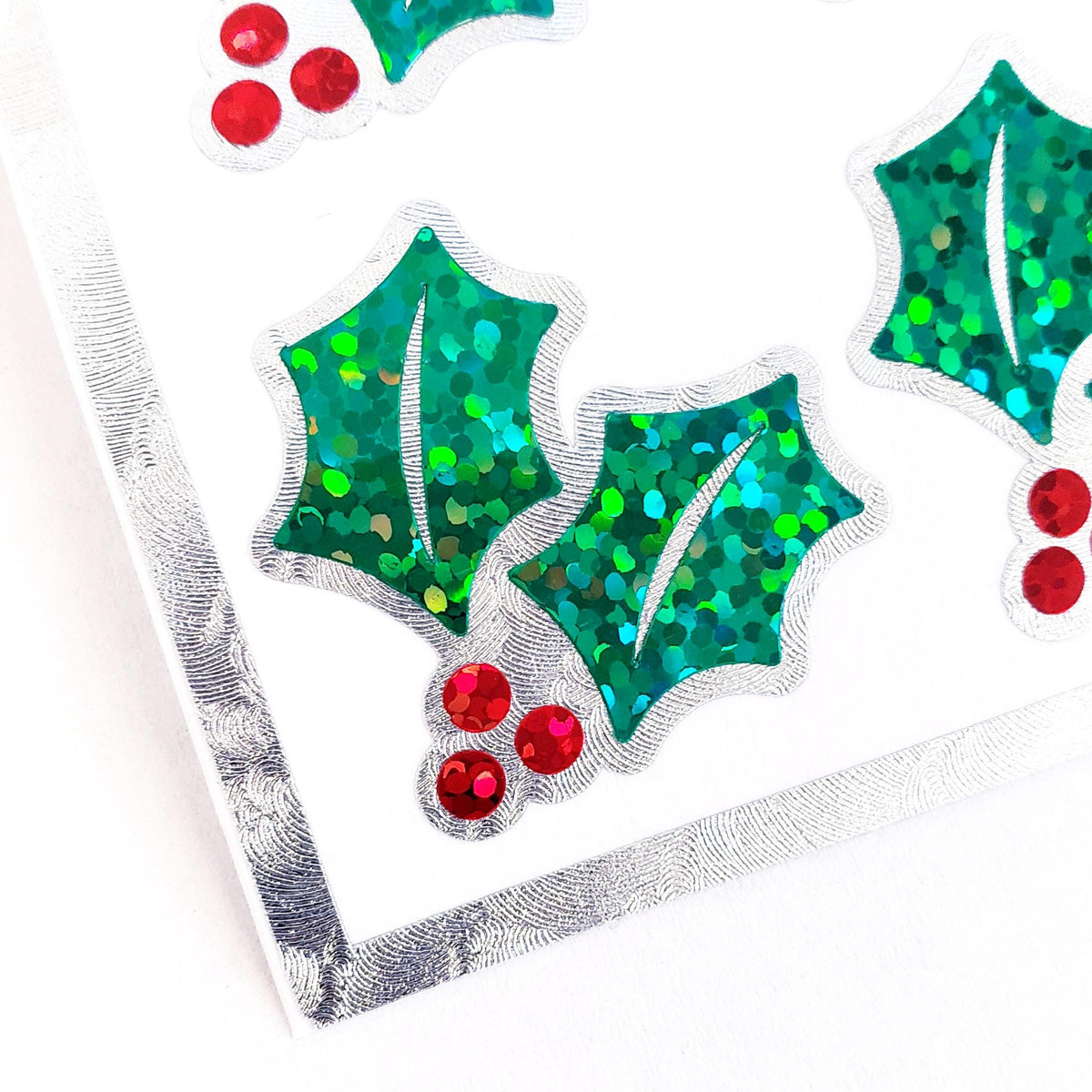 Christmas Holly Stickers, set of 20 sparkly red berry and green holly leaf stickers for holiday decor, gift tags and cards. Silver outline.