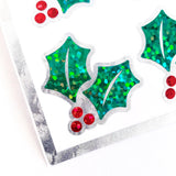 Christmas Holly Stickers, set of 20 sparkly red berry and green holly leaf stickers for holiday decor, gift tags and cards. Silver outline.