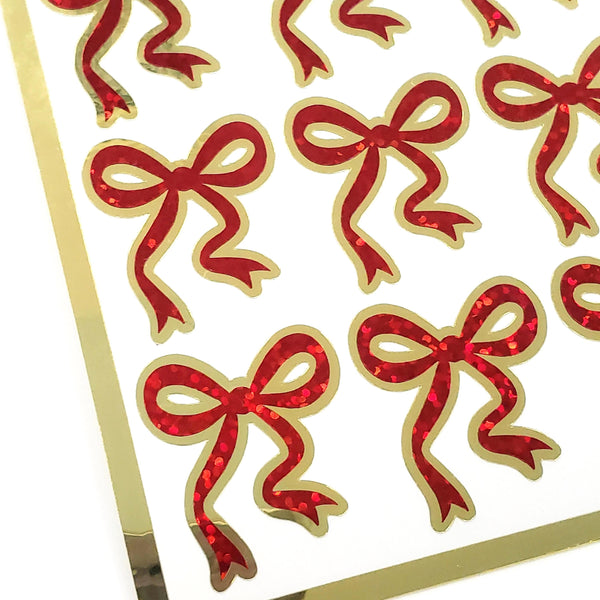 Sticker sheet with a set of 20 small red sparkly bow stickers with gold outline.