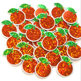 A collection of orange glittery fruit-shaped sticker embellishments with clear borders and green leaf accents. These decorative pieces are ideal for crafting projects, scrapbooking, or adding a touch of sparkle to various DIY creations. The orange fruit shapes are approximately 1 inch in diameter.