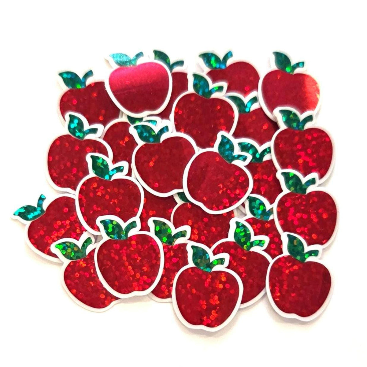 mini red apple glitter stickers with green leaf and clear outline.