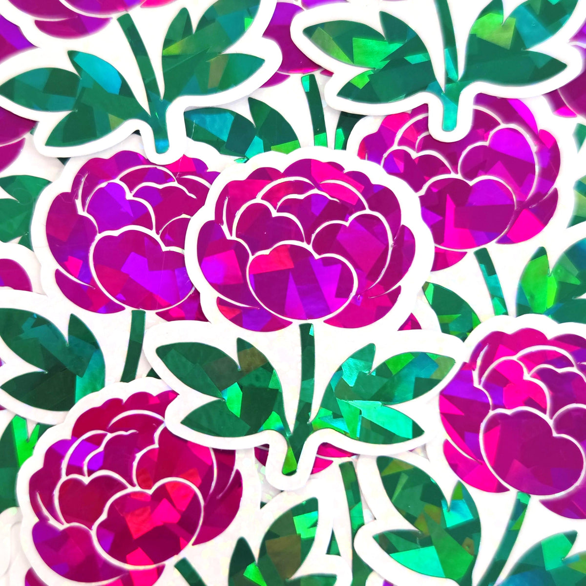 A collection of vibrant stickers featuring a peony flower design. The flowers are a mix of pink and purple with a holographic effect. Green leaves and stems complete the floral arrangement.