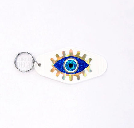 Retro Motel Style Keychain, white plastic key holder with sparkly blue and gold evil eye graphics, gift under 10 dollars