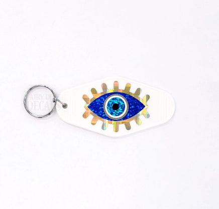 Evil Eye Keychain, retro motel style, black plastic key holder with sparkly blue eye graphics, gift under 10 dollars