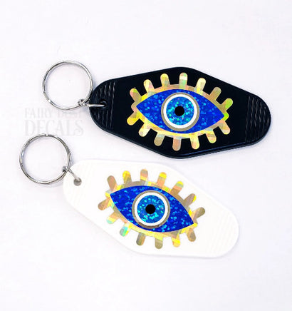 Evil Eye Keychain, retro motel style, black plastic key holder with sparkly blue eye graphics, gift under 10 dollars